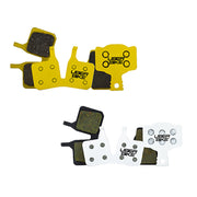 Sets of yellow, black, and white brake pads with Uberbike branding on a white background.