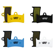 Four pairs of Uberbike brake pads in yellow, black, blue, and white on a white background.