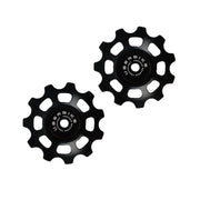 two black ceramic 11 tooth jockey wheels on a white background