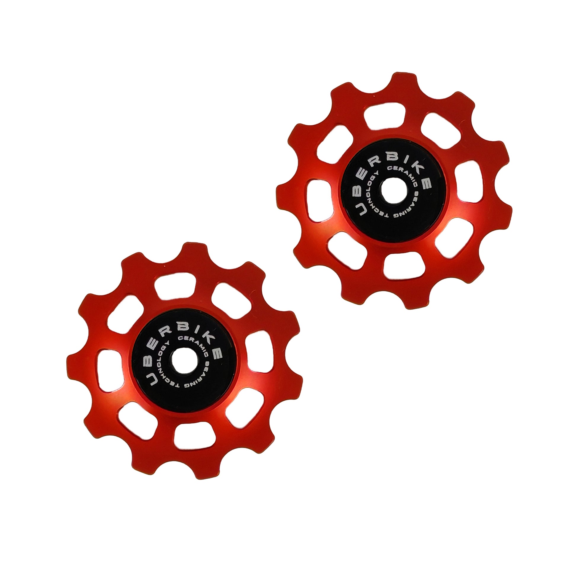 two orange ceramic 11 tooth jockey wheels on a white background