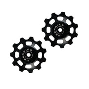 two black steel 11 tooth jockey wheels on a white background