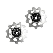 two silver steel 11 tooth jockey wheels on a white background