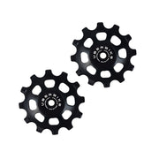two black ceramic 12 tooth jockey wheels on a white background