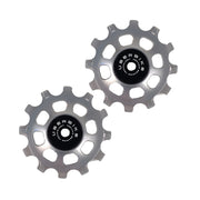 two silver ceramic 12 tooth jockey wheels on a white background