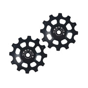 two black steel 12 tooth jockey wheels on a white background