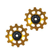 two gold steel 12 tooth jockey wheels on a white background