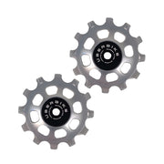 two silver steel 12 tooth jockey wheels on a white background