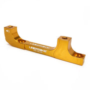 a gold post mount to post mount disc brake adapter for 160mm-220mm disc brake rotor on a white background