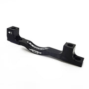 a black post mount to post mount disc brake adapter for 180mm-220mm disc brake rotor on a white background