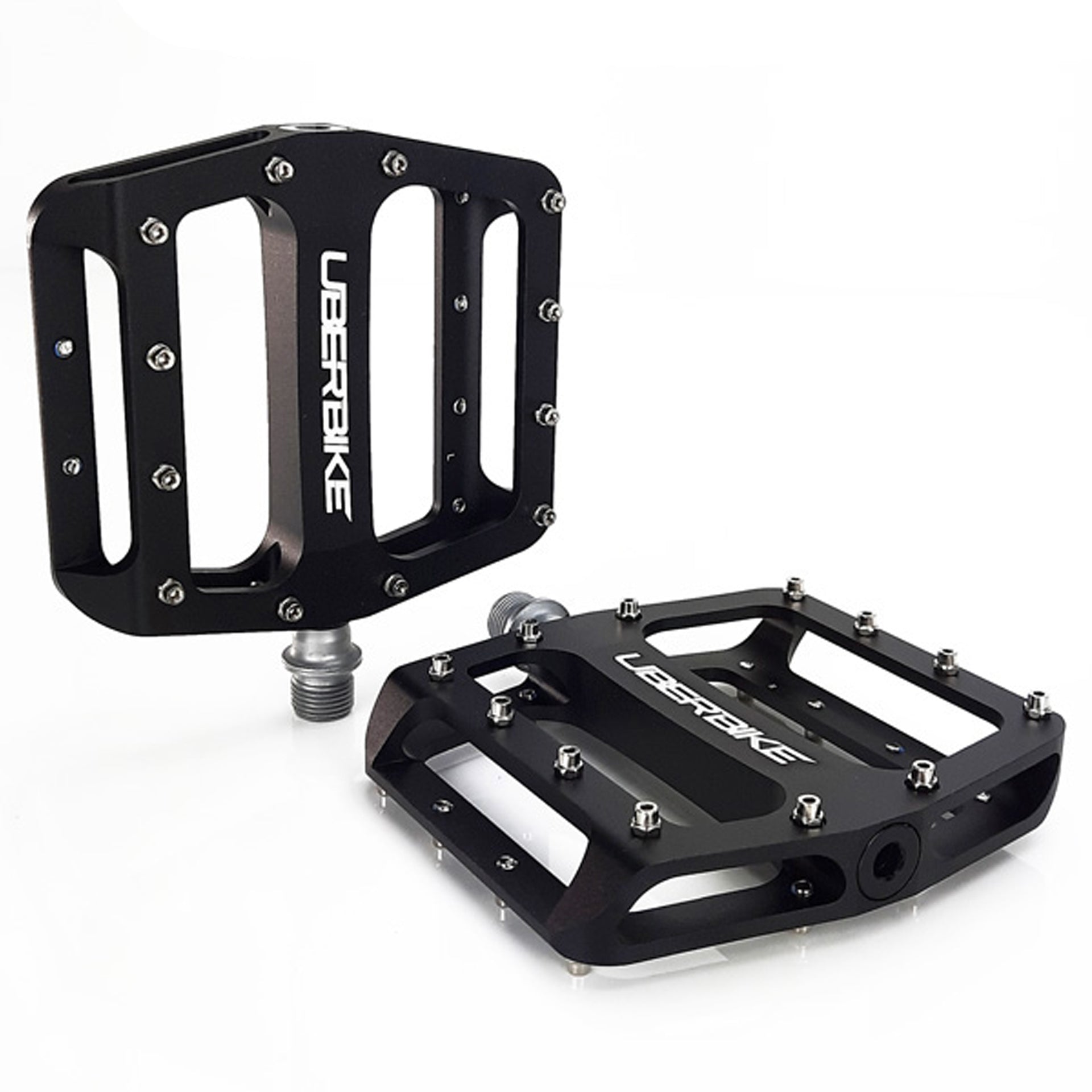 two black pedals with raw coloured pedals pins on a white background