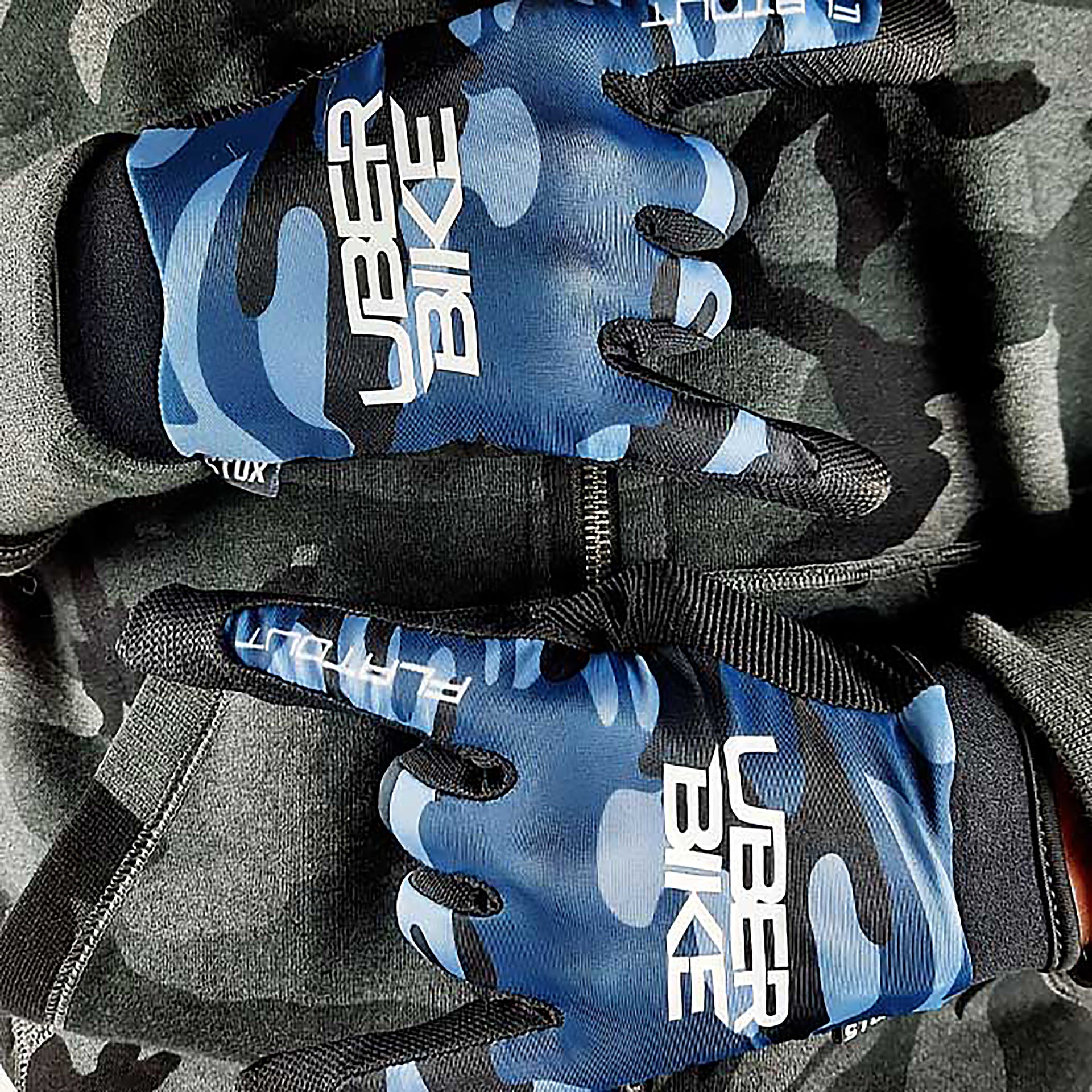 Blue camouflage gloves with Uberbike branding on a black background 