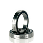 two ceramic bottom bracket bearings on a white background