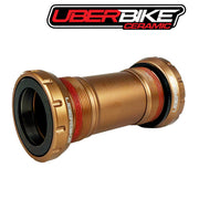 Uberbike ceramic MTB/Road bottom bracket in a bronze colour on a white background with Uberbike logo above.