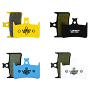 Four sets of Uberbike brake pads in different colors on a white background.