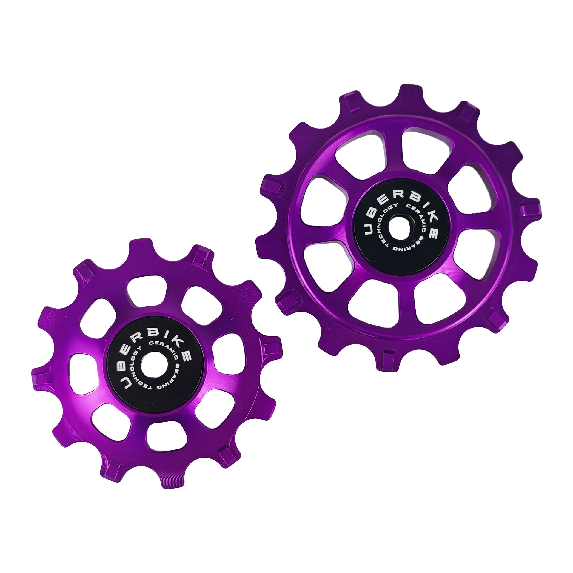one ceramic purple 12 tooth and one 14 tooth jockey wheel on a white background