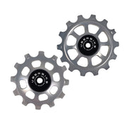 one ceramic silver 12 tooth and one 14 tooth jockey wheel on a white background