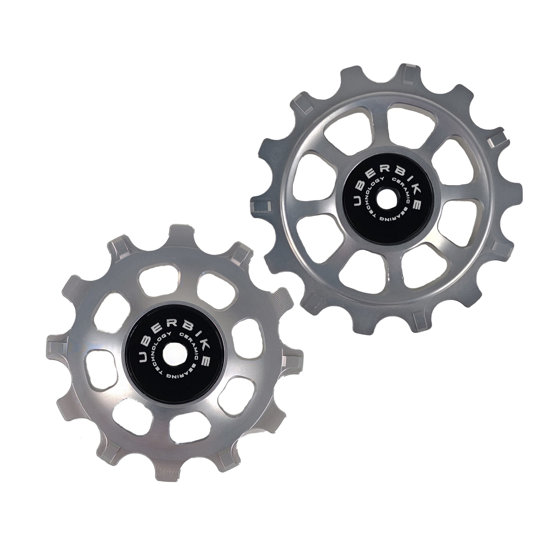 one ceramic silver 12 tooth and one 14 tooth jockey wheel on a white background