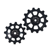 one black steel 12 tooth and one 14 tooth jockey wheel on a white background