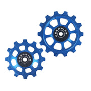 one blue steel 12 tooth and one 14 tooth jockey wheel on a white background