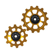 one gold steel 12 tooth and one 14 tooth jockey wheel on a white background