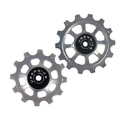 one silver steel 12 tooth and one 14 tooth jockey wheel on a white background