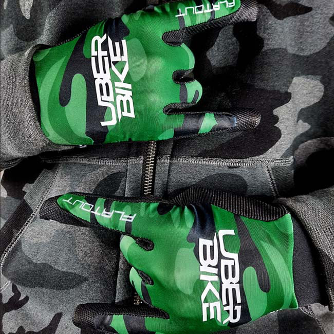 Green camouflage gloves with 'Uber Bike' branding on a gray camouflage background
