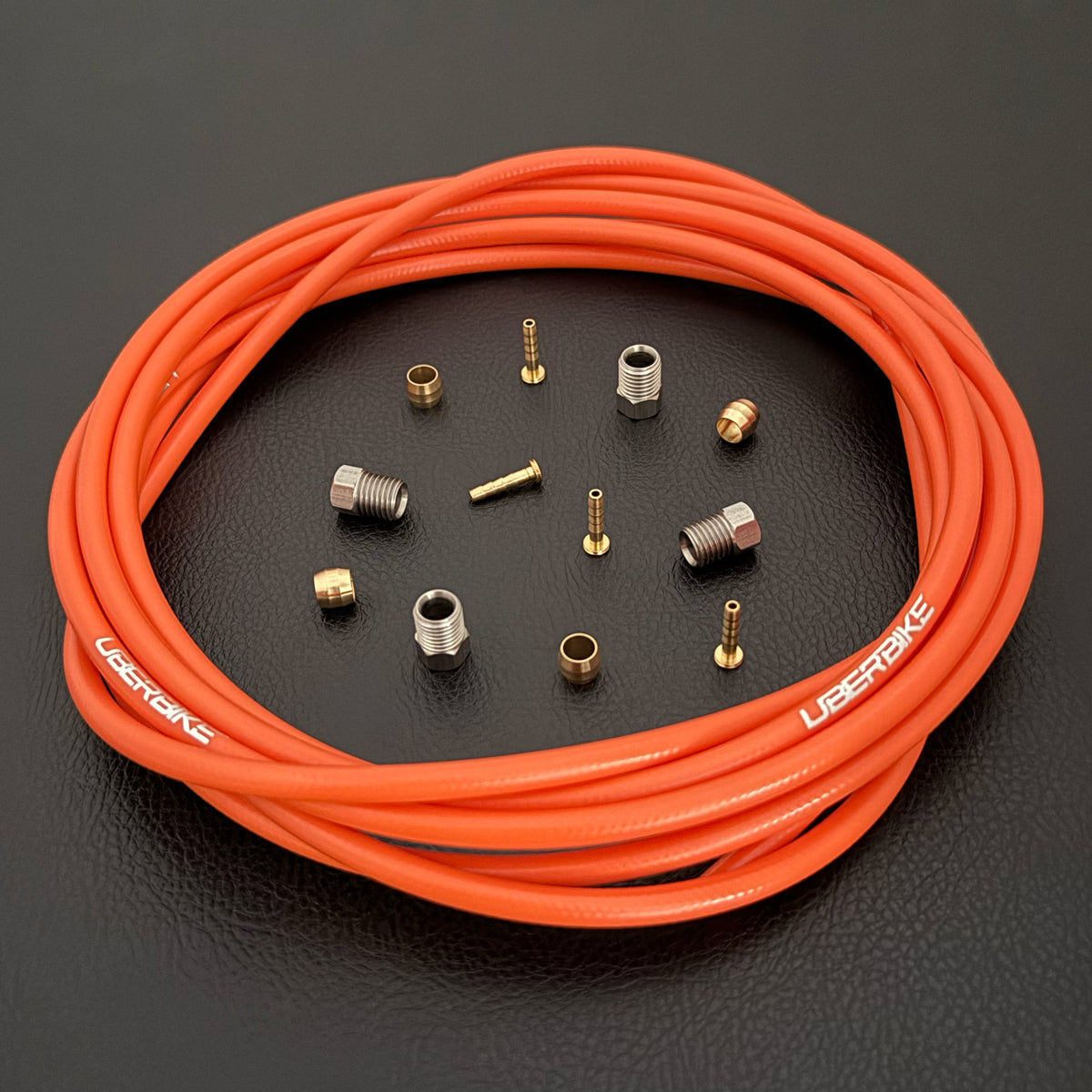 Formula Cura / Cura 4 / Cura X orange hydraulic brake hose kit with straight connector fittings and Uberbike branding on a black background