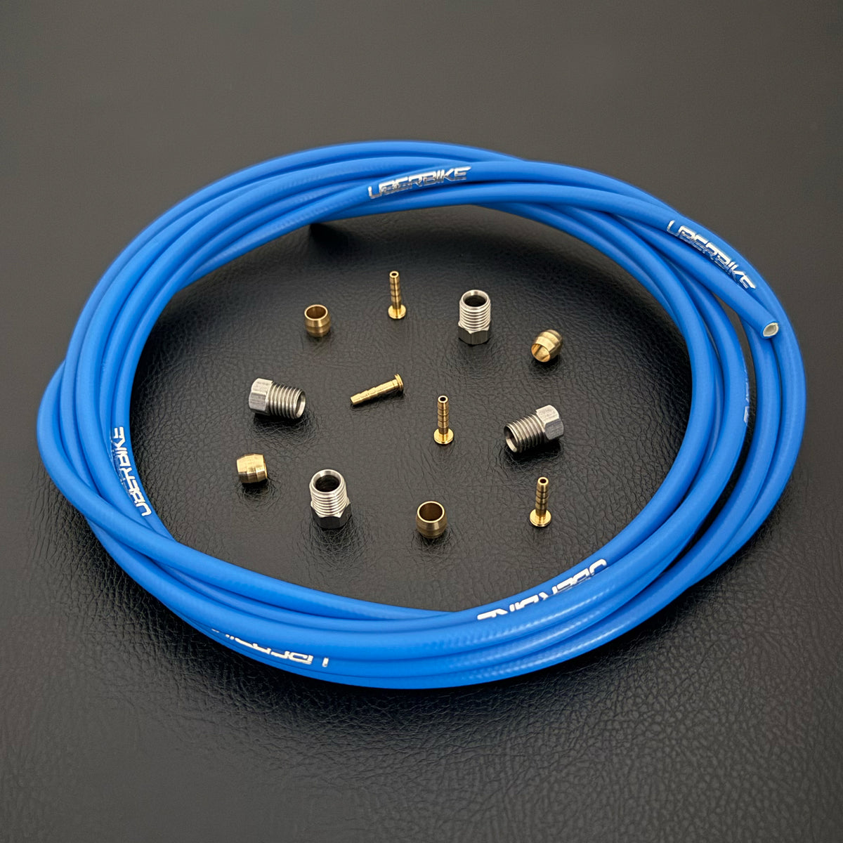 Formula Cura / Cura 4 / Cura X blue hydraulic brake hose kit with straight connector fittings and Uberbike branding on a black background
