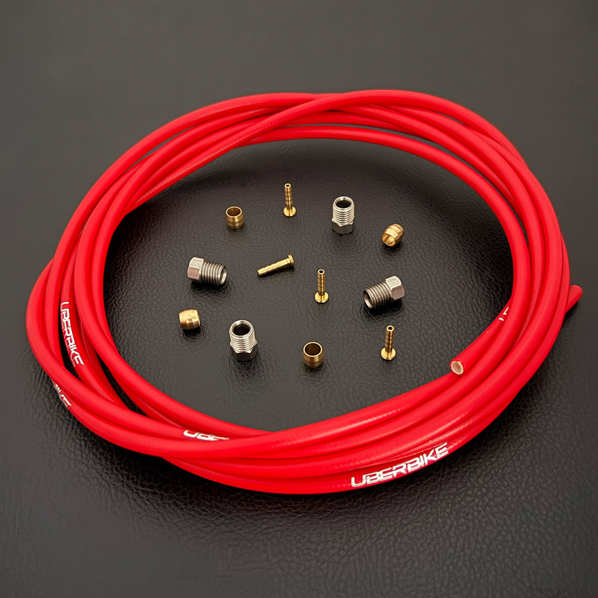 Formula Cura / Cura 4 / Cura X red hydraulic brake hose kit with straight connector fittings and Uberbike branding on a black background