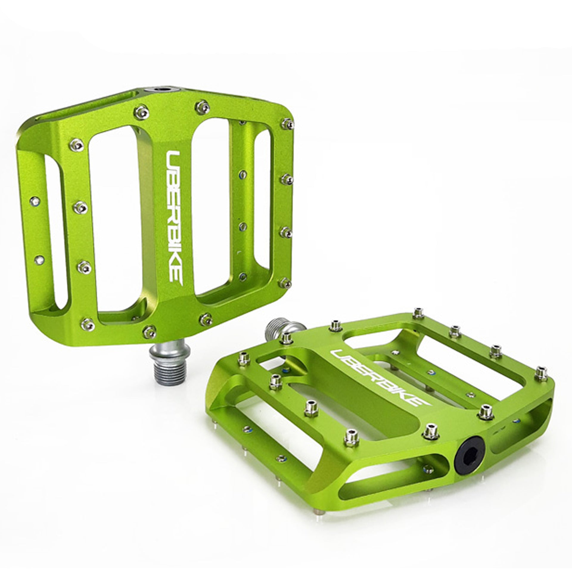 two green pedals with raw pedal pins on a white background