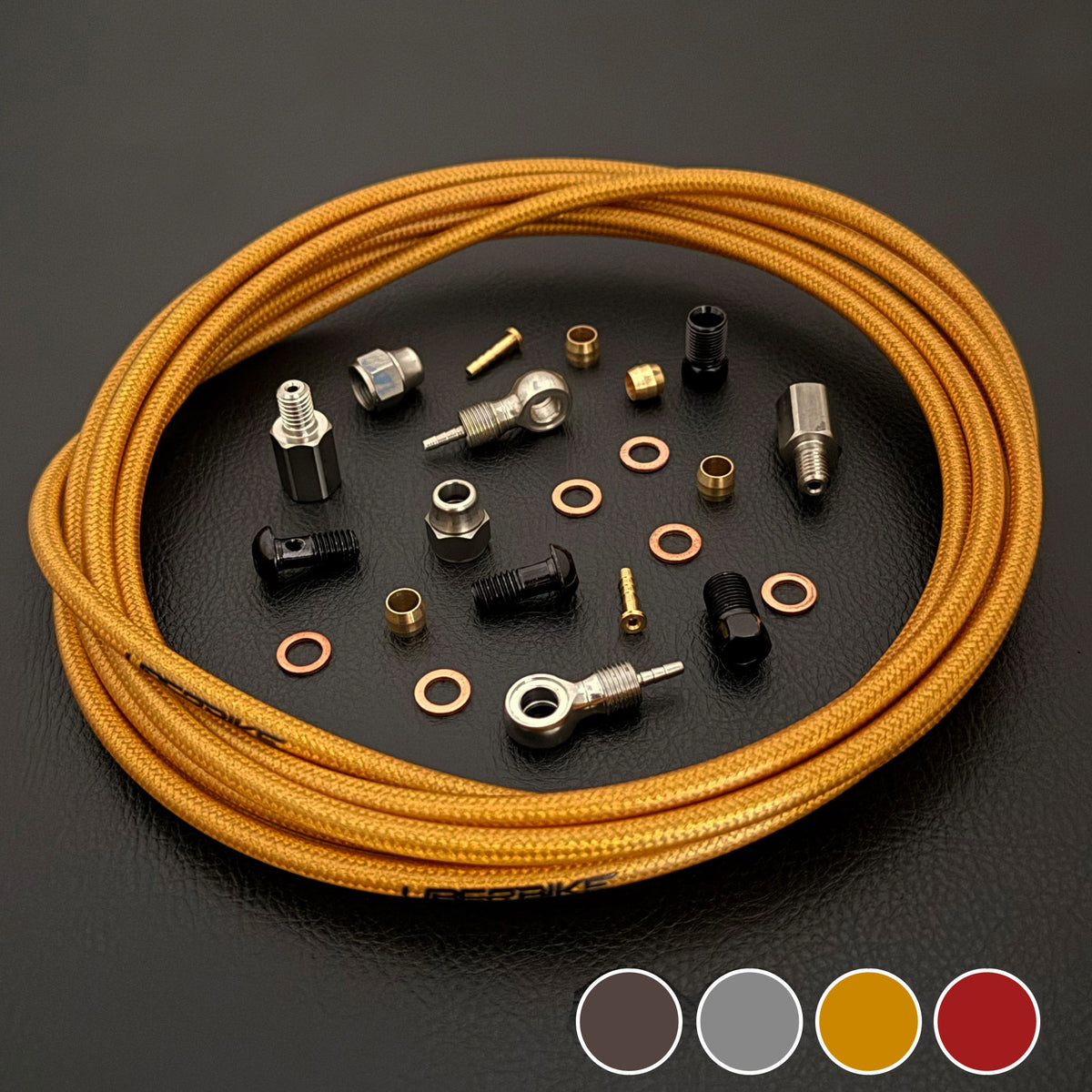Hope tech 4 e4 gold braid kevlar hydraulic brake hose kit with banjo fittings and Uberbike branding on a black background with a colour panel in the bottom right hand corner