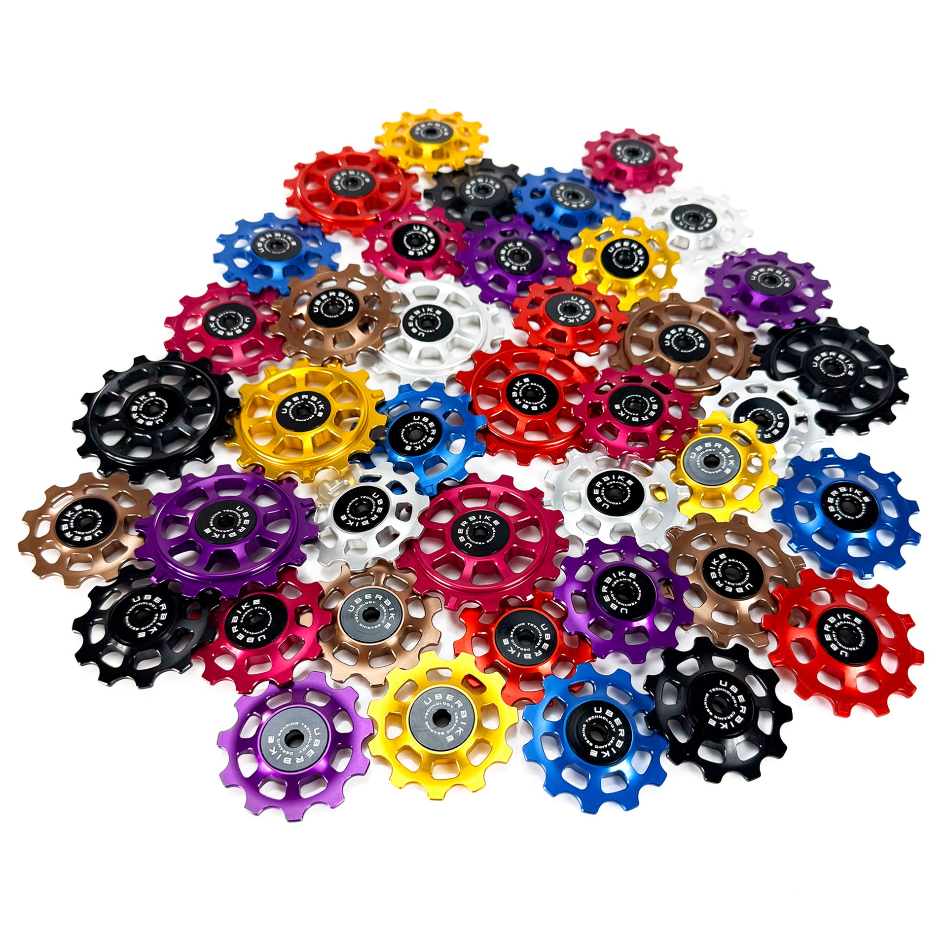 A variety of different sized and coloured jockey wheels with Uberbike branding on a white background