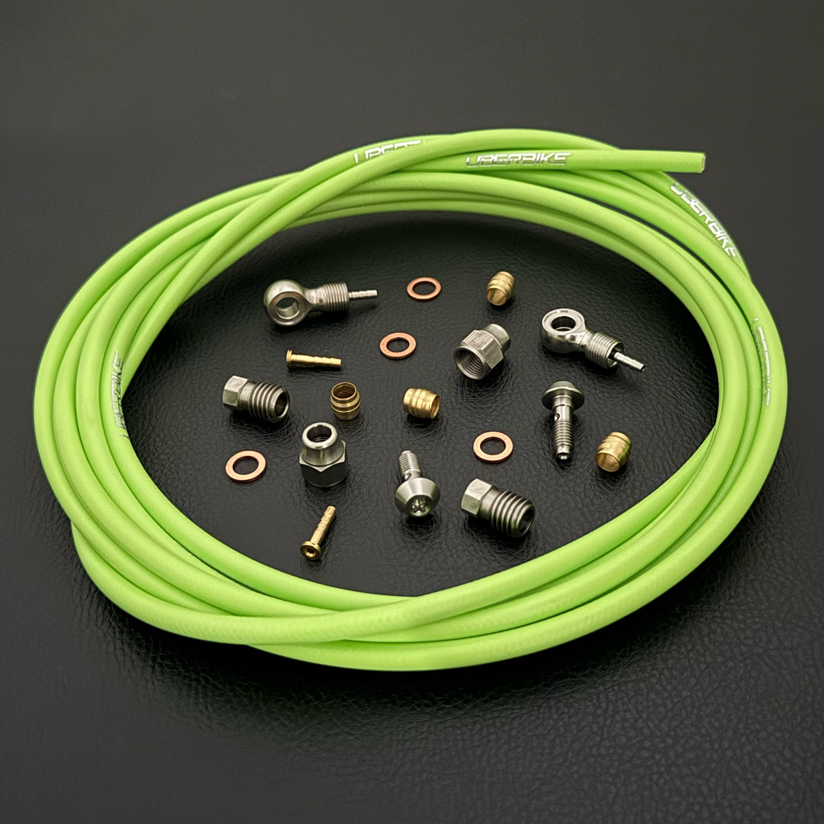 Magura MT4 green hydraulic brake hose kit with banjo fittings and Uberbike branding on a black background 