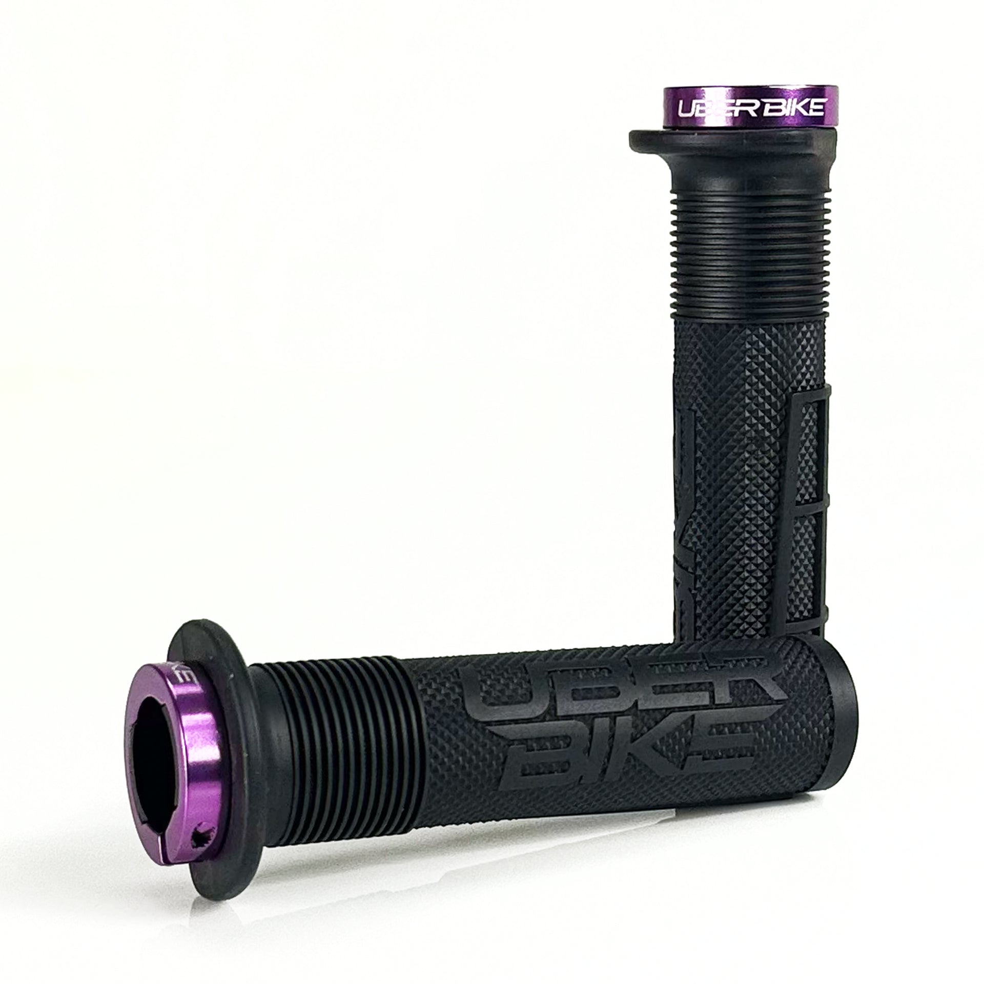 two black mushroom waffle mountain  bike grips and purple lockrings on a white background