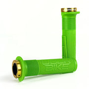 two green mushroom waffle mountain  bike grips and gold lockrings on a white background