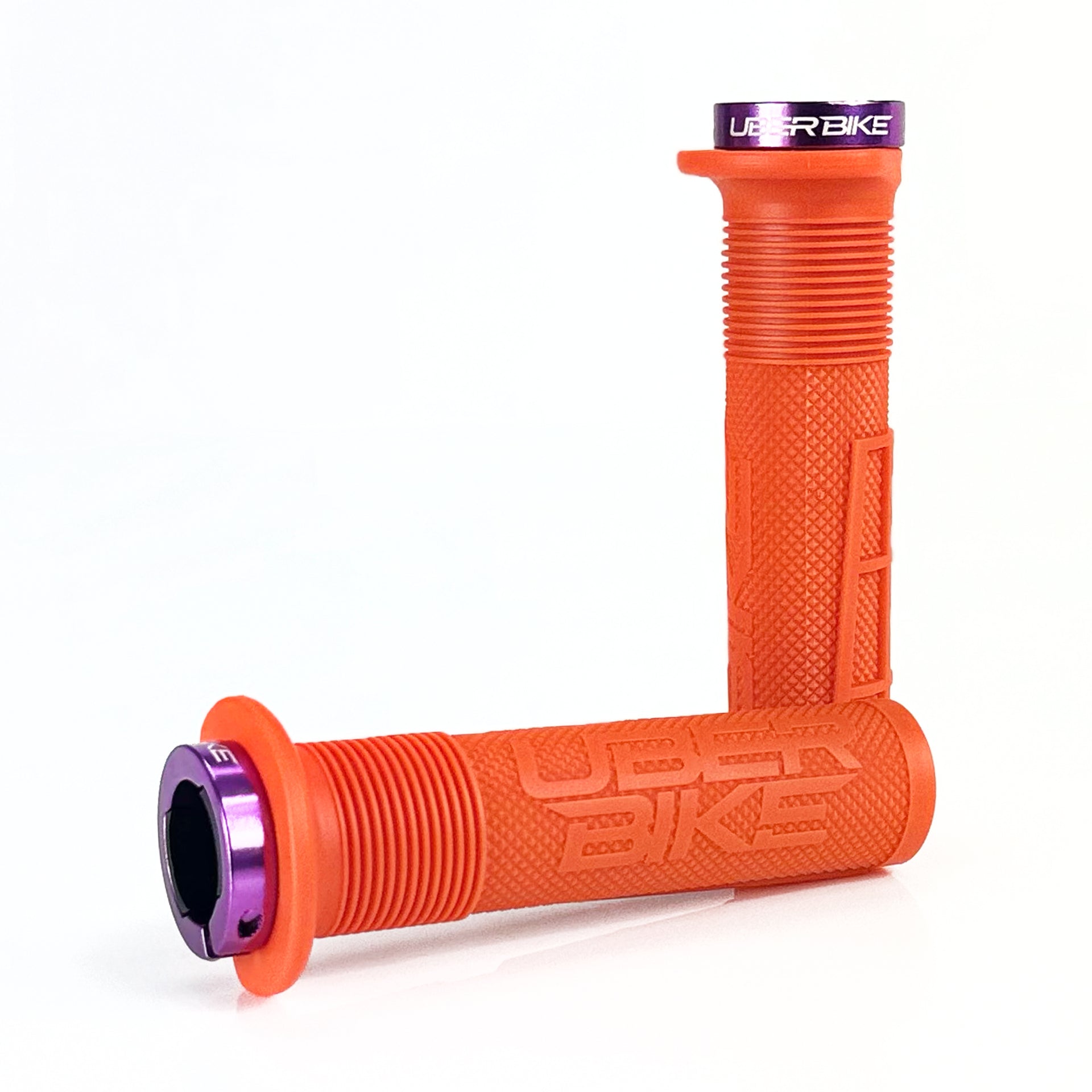 two orange mushroom waffle mountain  bike grips and purple lockrings on a white background