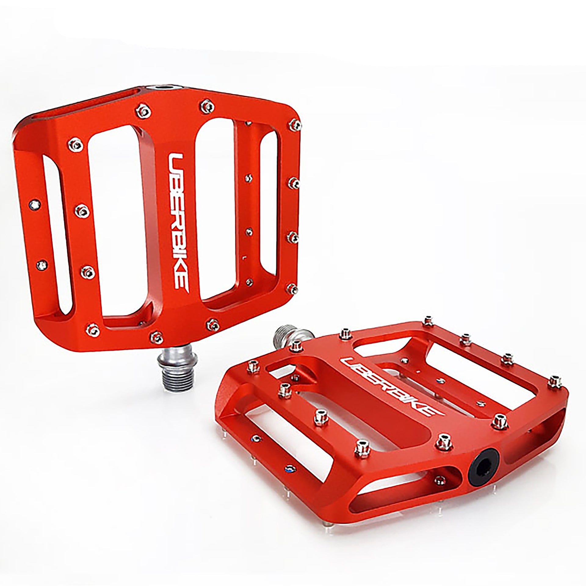 two orange pedals with raw pedals pins on a white background