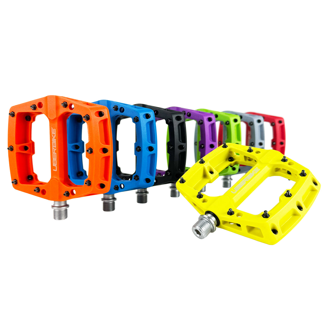 Range of colourful bicycle pedals with Uberbike branding on a white background