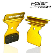 Gold colour brake pads with Uberbike branding on a white background, featuring the Polar Tech logo.