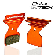Orange brake pads with Uberbike branding on a white background, featuring the Polar Tech logo.