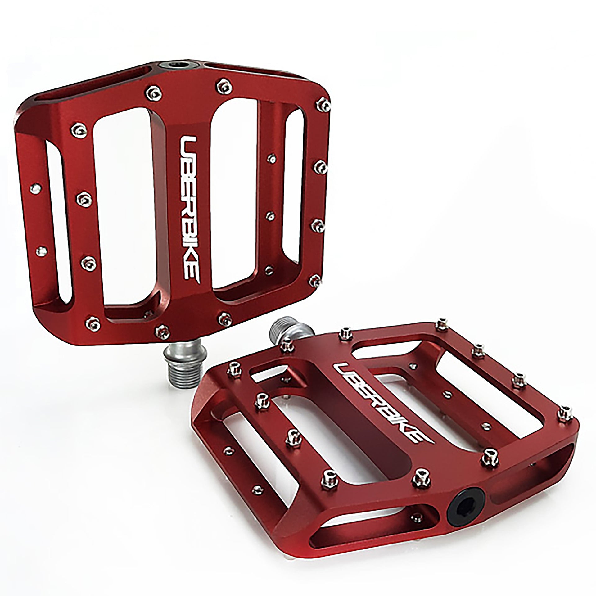 two red pedals with raw pedal pins on a white background