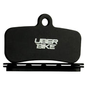 SHIMANO 4 PISTON bicycle brake pad with a white 'UBER BIKE' logo, displayed on a black vented pad on white background
