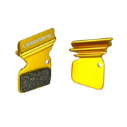 gold finned sram apex 1 brake pads on a white background