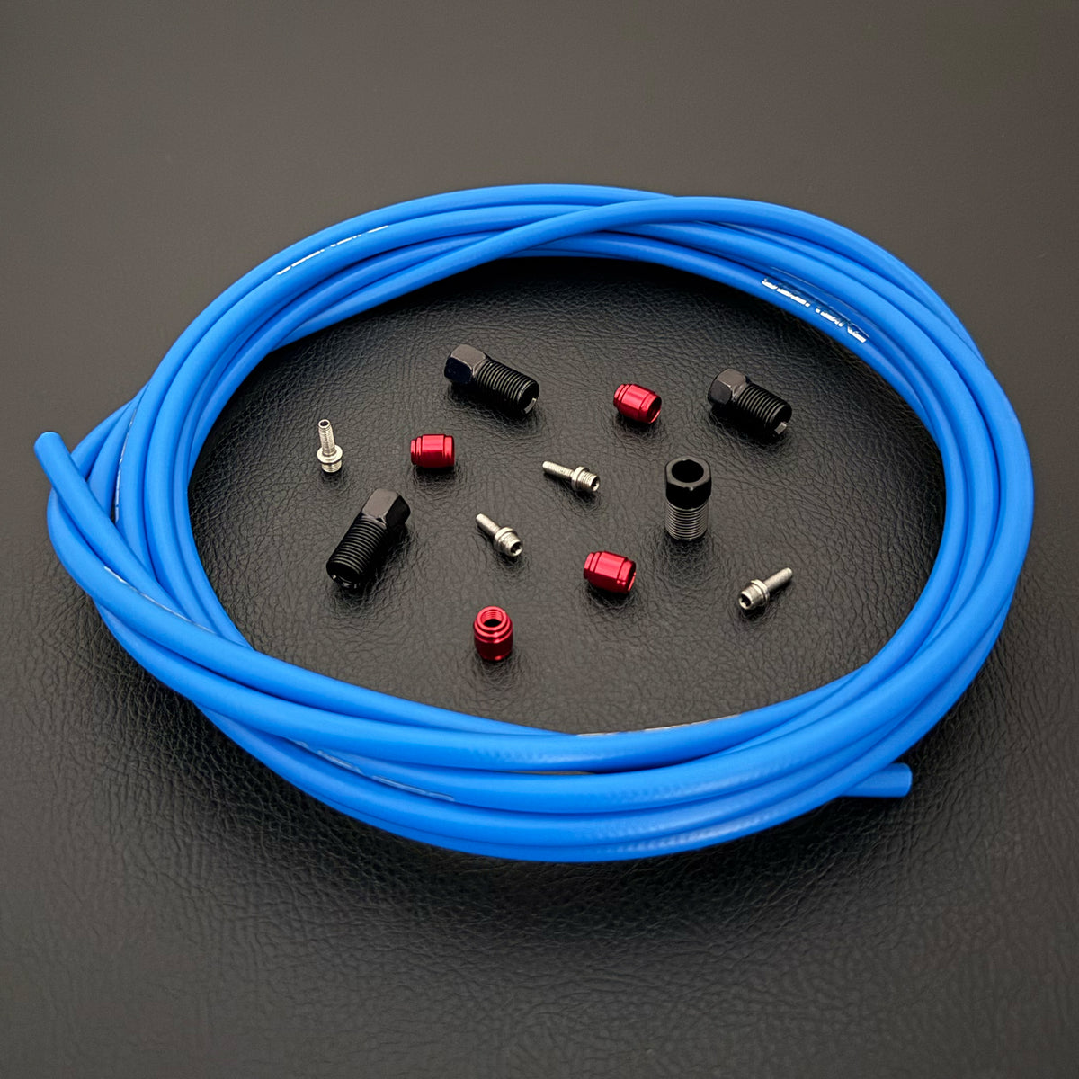 SRAM Code Stealth Bronze hydraulic blue brake hose kit with straight connector stealthmajig fittings and Uberbike branding on a black background