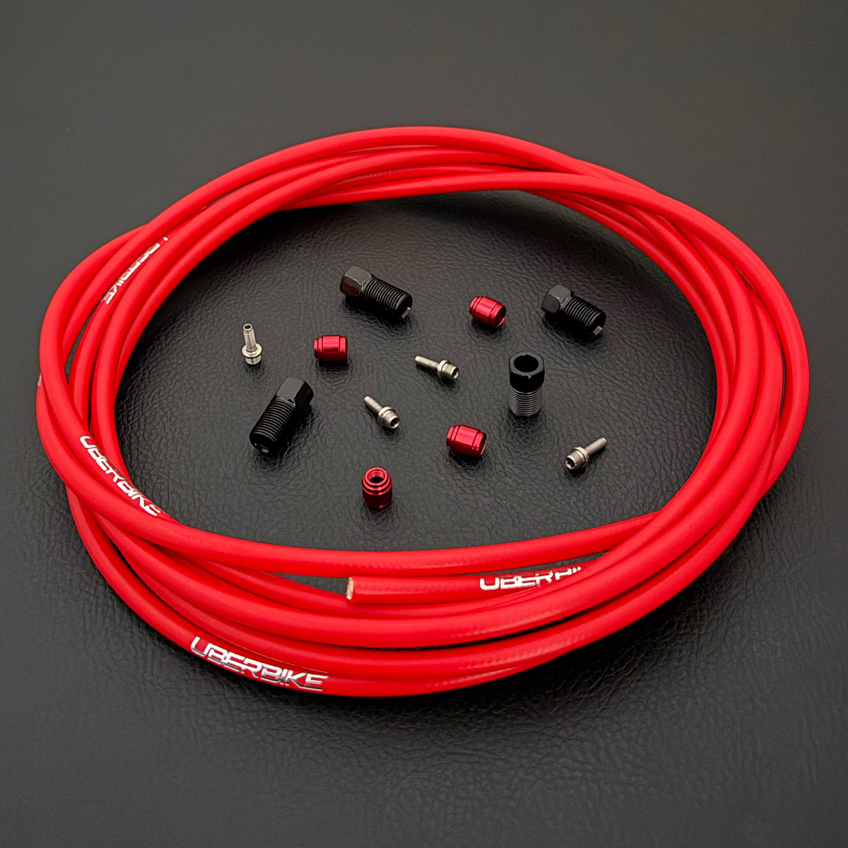 SRAM Code Stealth Bronze hydraulic red brake hose kit with straight connector stealthmajig fittings and Uberbike branding on a black background