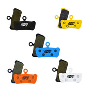 5 different coloured sram G2 brake pads with Uberbike branding on a white background