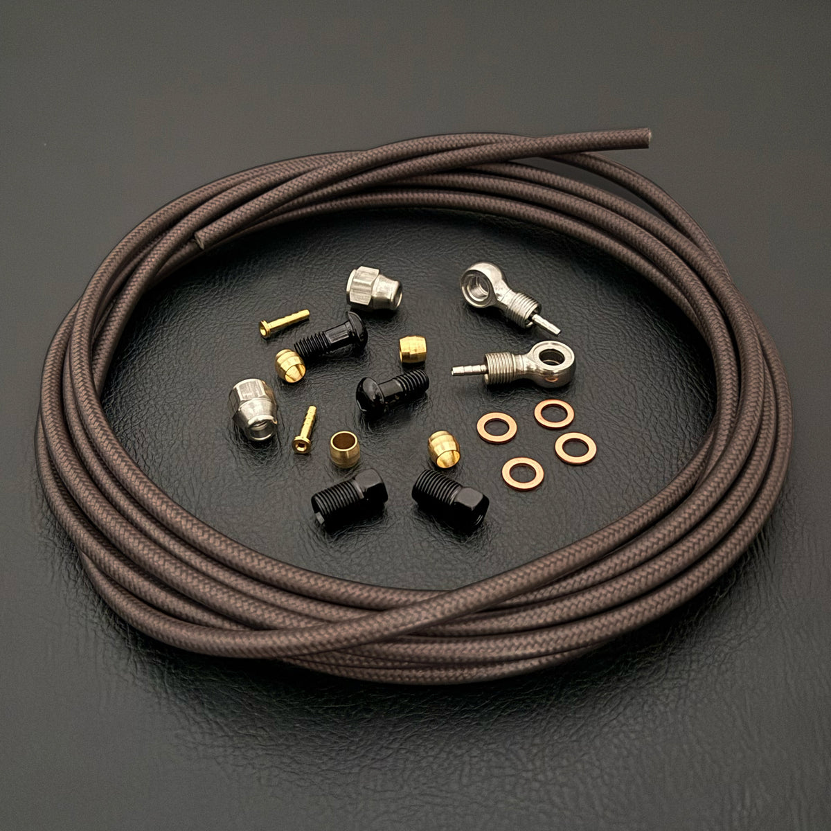 SRAM Level 4P smoke braid kevlar hydraulic brake hose kit with silver banjo fittings and Uberbike branding on a black background