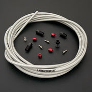 SRAM motive Bronze hydraulic raw silver braid kevlar brake hose kit with straight connector stealthmajig fittings and Uberbike branding on a black background