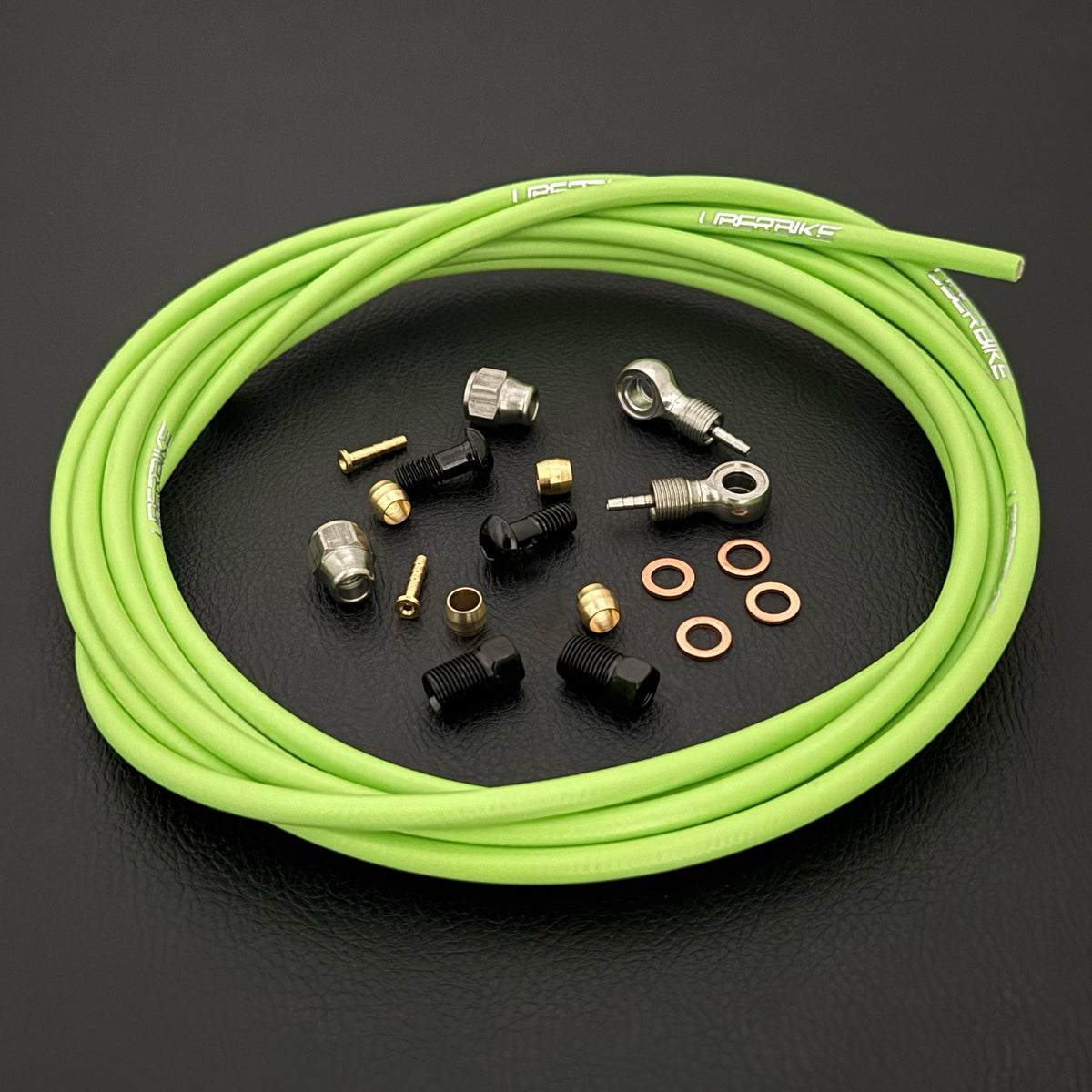 SRAM XX hydraulic green brake hose kit with silver banjo fittings and Uberbike branding on a black background