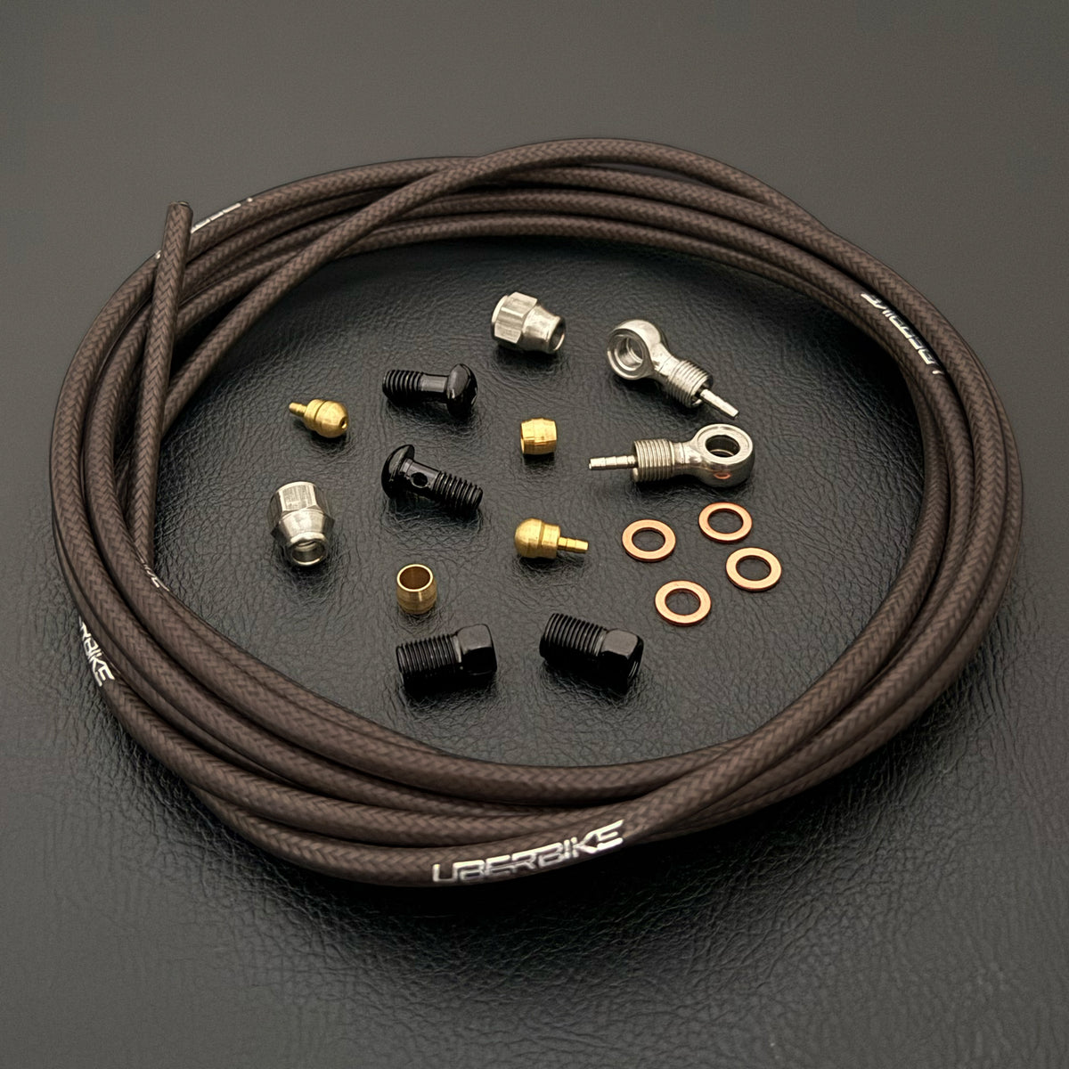 SRAM XX hydraulic smoke braid stainless brake hose kit with silver banjo fittings and Uberbike branding on a black background